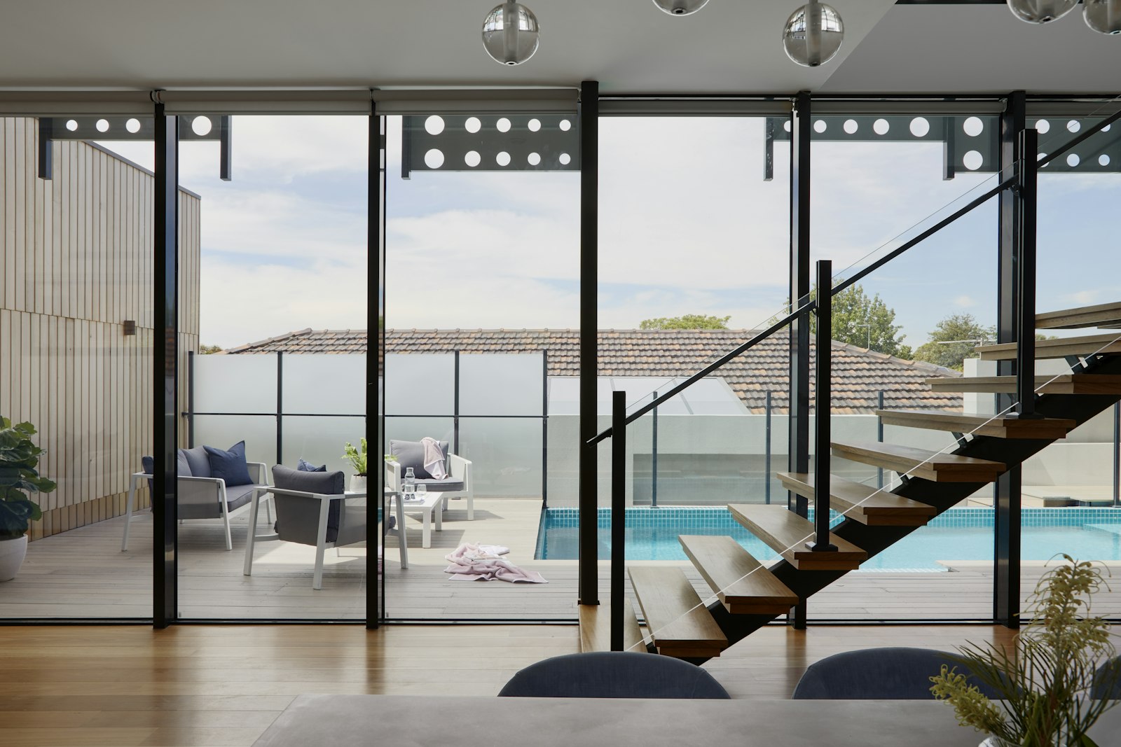 Glass staircase above a pool